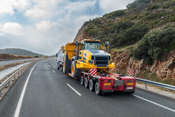 Special transport truck carrying large construction machinery on a trailer, rear view © M. Perfectti