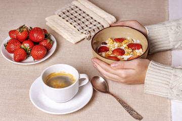 Healthy breakfast with yogurt, granola and fresh berries in hands