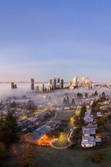 Obraz premium Sunrise Over Foggy Vancouver Skyline With Urban Core And Suburban Neighborhoods, BC, Canada