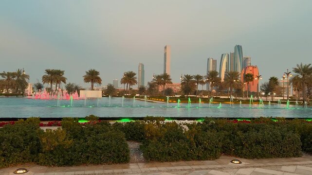 Stunning view of the modern skyline in Abu Dhabi, UAE, featuring iconic Etihad Towers and skyscrapers standing tall under a clear blue sky during a sunny day.

