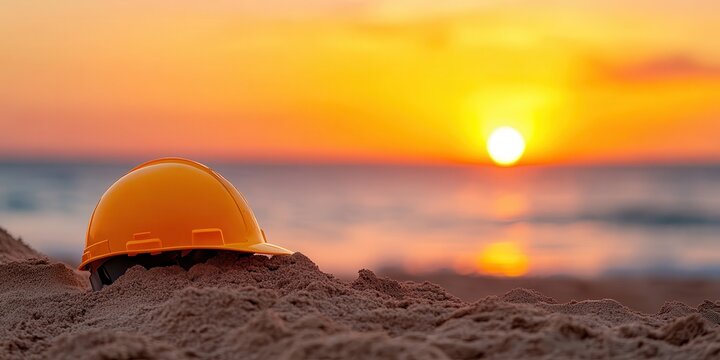 Sunset glow on a civil construction helmet resting on warm sand