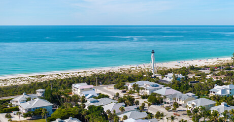 Famous lighthouse on ocean shore and expensive residential houses in island small town Boca Grande on Gasparilla Island in southwest Florida © bilanol