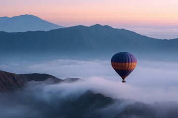 Fototapeta premium Vibrant hot air balloon marvel over serene misty mountains at sunrise