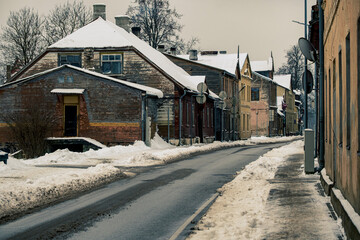 old town street with small houses in winter. Jaunjelgava town, Latvia. Snow on street