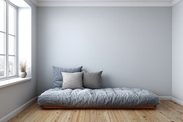 Minimalist room features a floor mattress with pillows by a window.