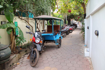 tuk-tuk and motorbikes in siem reap in cambodia