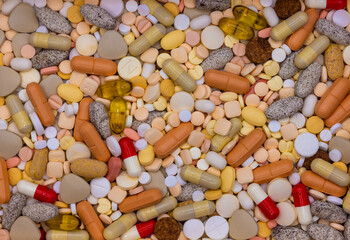 Close-up with colorful assortment of various medicine pills and capsules. Many different types of medical pills, tablets, and capsules