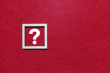 White question mark in square frame on red background
