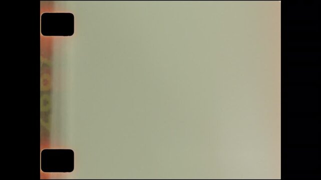 Sixteen millimeter film scan with sprocket holes and light leaks exposed.  Film grain overlay or design element.