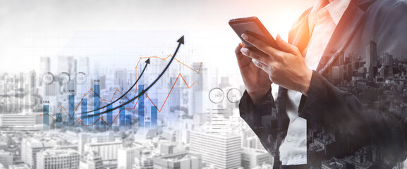 A business professional engages with a smartphone while analyzing data trends and financial growth against a dynamic city backdrop, showcasing modern technology and strategy. Scalp