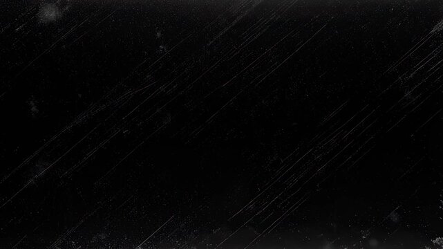 Abstract black surface with countless small white dots and long, thin scratches