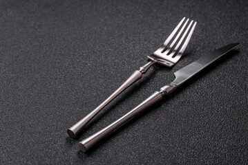 A knife and fork, silver kitchen utensils for the dining table. A knife and fork