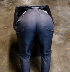 Failed Businessman Stuck in Trash Can. Over a Barrel. Concept of Being Sacked or Fired. Victim of Stock Market Crash.