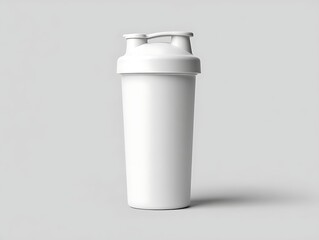 Obraz premium A white plastic shaker bottle on a plain gray background with subtle shadows