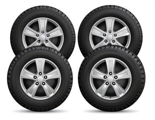 Fototapeta premium Set of four car tires with silver rims on white background.