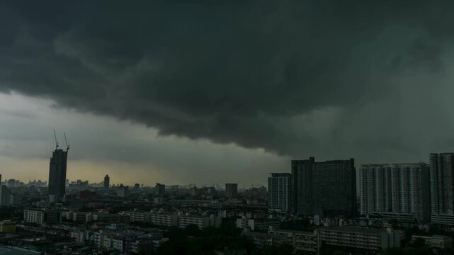 Dramatic wide angle view of a massive shelf cloud rolling over a modern City Skyline. An Intense Meteorological Phenomenon Illustrating Severe Weather, Urban Resilience, and Power of a .Thunderstorm.