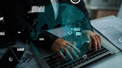 A business professional focuses intently on a laptop, with a digital world map overlay enhancing the theme of global data analysis and modern technology. Xenic