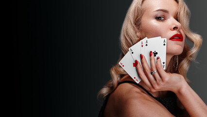 Glamorous blonde woman in a black shiny dress with expensive diamond jewelry after winning Omaha...