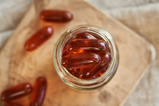 Lecithin capsules or pills in a glass jar. Nutritional supplement.