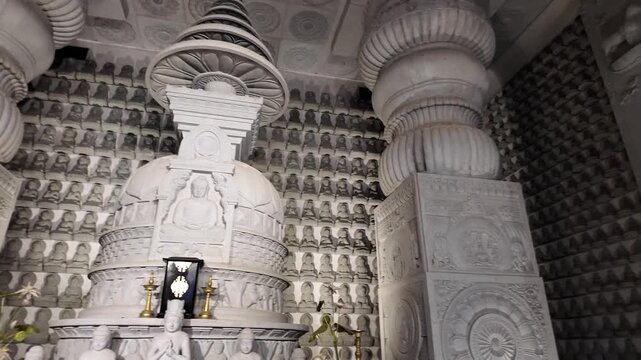 White Stone Statue of Multi-Armed Deity in Intricate Temple Interior