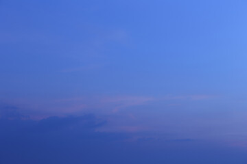 Obraz premium Tranquil and Serene Dawn Sky with Soft Blue Hues and Gentle Cotton Clouds, Capturing the Essence of Nature's Beauty at Sunrise