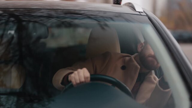Man Passionately Communicates While Driving His Modern Car Through Urban Streets