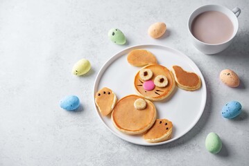 Sweet pancakes in the form of rabbit with chocolate and banana on top