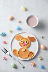 Sweet pancakes in the form of rabbit with chocolate and banana on top