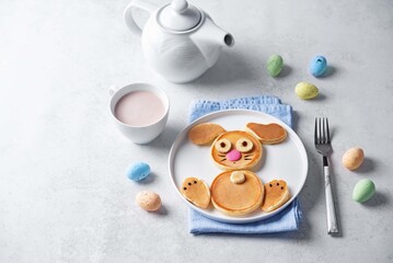 Sweet pancakes in the form of rabbit with chocolate and banana on top