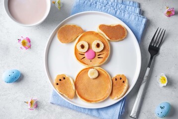 Sweet pancakes in the form of rabbit with chocolate and banana on top