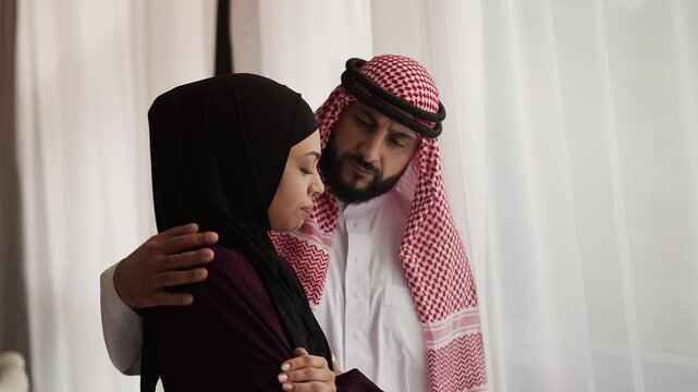 Arab man hugging sad spouse and offering comfort, care and emotional support