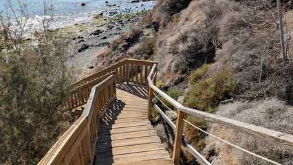 Wooden steps leading to rocky beach in Costa Calma, Fuerteventura. 