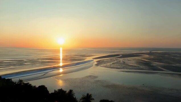 Beautiful 4K timelapse of sunrise over the Minas Basin capturing tides rushing across expansive mudflats as warm morning light transforms the coastal 