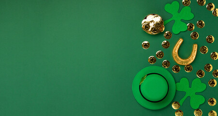 St. Patrick's Day Leprechaun Hat, Gold Coins, Shamrocks and Party Favors on Green Background.