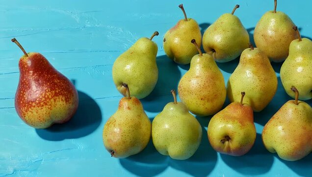 High resolution 4K top view tracking shot of Kaiser Bosc pears displayed on blue background emphasizing shape color contrast premium fruit 