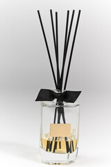 Glass bottle with fragrance sticks on white background, spa and fragrance concept