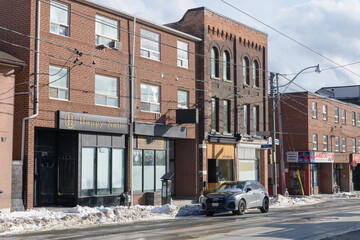 Naklejka premium wide view of buildings on Broadview Av incl 265 Broadview Av, site of Lady Marmalade, a brunch spot, Toronto