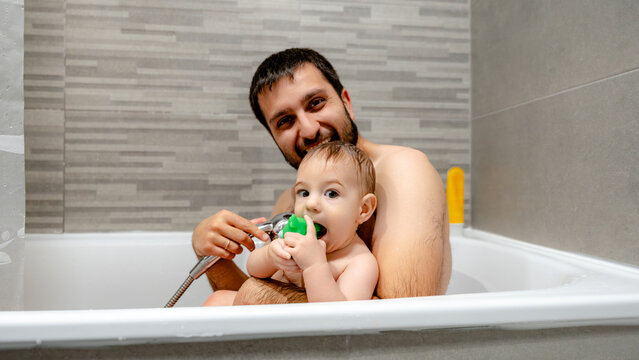 Baby and dad enjoying bath time together