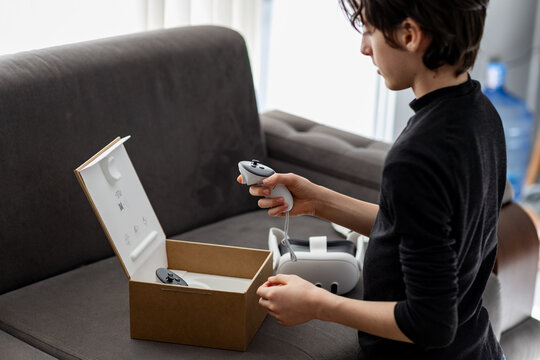 Teenager exploring virtual reality at home