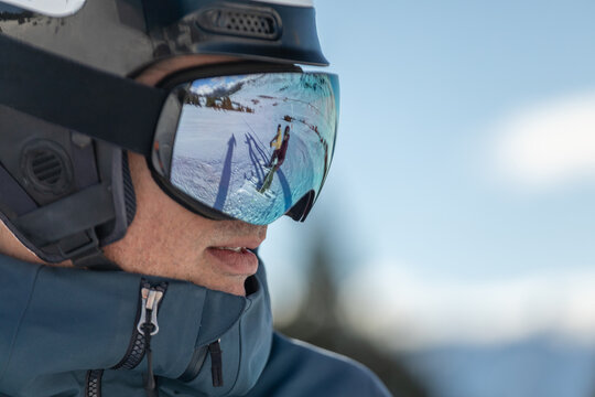 Reflection of skier on goggles in Pyrenean Mountains