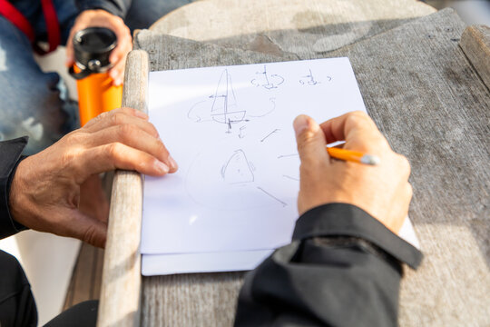 Sailor sketching navigation plan in Lofoten