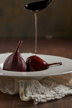 Poached pears drizzled with red wine sauce
