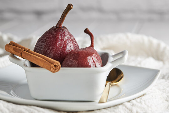 Pears poached in red wine with cinnamon sticks
