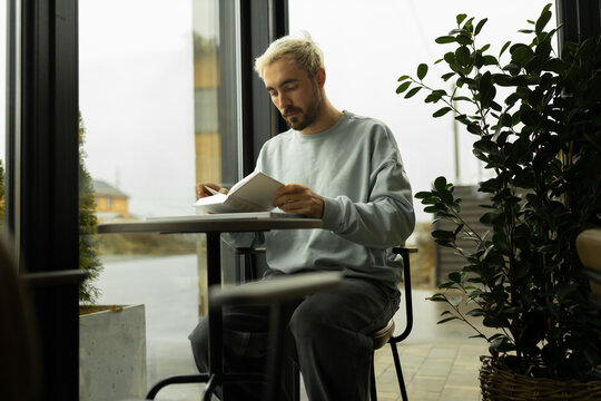 Man reading the Holy Bible in a cafe