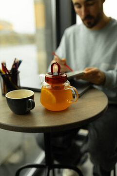 Man reading the Holy Bible while enjoying tea at a cafe