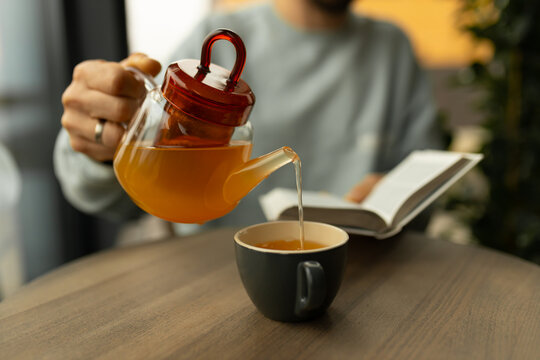 Pouring tea while reading the Holy Bible