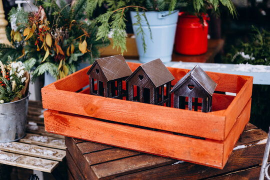 Miniature wooden houses in a red crate