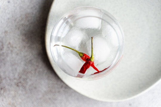 Vodka cocktail with spicy pepper on ice