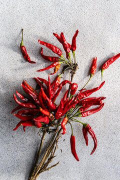 Fresh red chili peppers on textured concrete