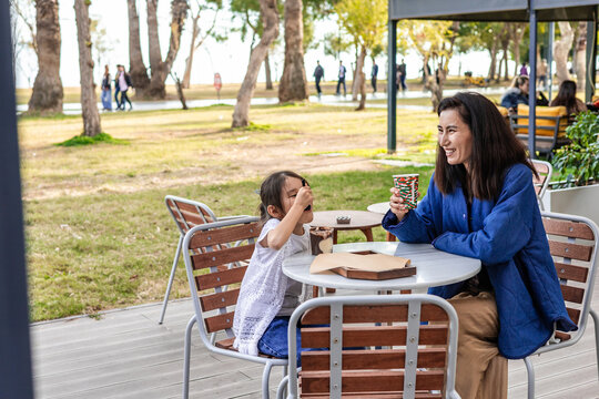 Mother and daughter enjoying outdoor cafe time
